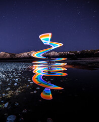 Light painted rainbow spiral and water reflection