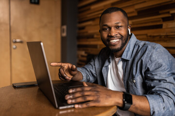Headshot portrait smiling african american business man making video call, looking at camera, confident positive young trainer leading a remote lesson, businessman participating in online conference.