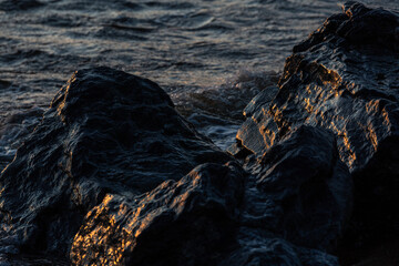 stones at sea at sunset and in the long exposition