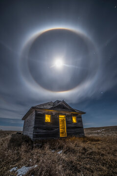Moon halo above an abandoned building, long exposure, light painted