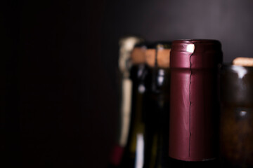 Bottles of red wine and sparkling wine on a dark background. Selective focus