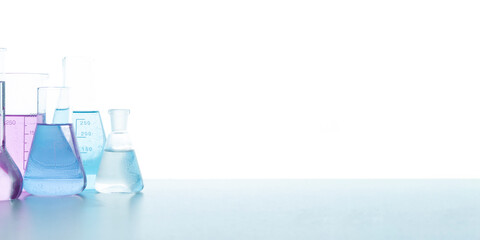 Chemical glassware with colored reagents on a white background. Selective focus. Medical, science...