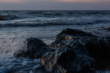 stones at sea at sunset and in the long exposition