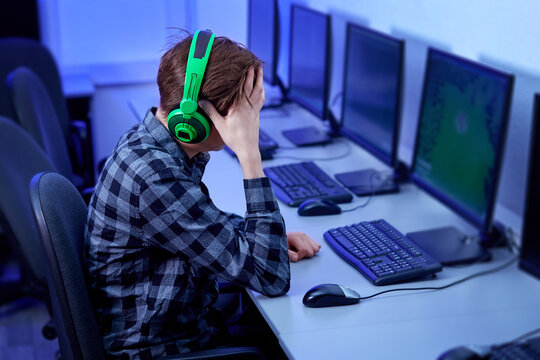 Frustrated professional gamer plays and loses the game online on his personal computer.