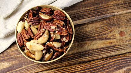 Assorted nuts close-up on a wooden background close-up selective focus.