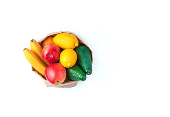 Juicy fresh fruit in a kraft bag isolated on a white background. Top view with copy space. The concept of healthy eating.