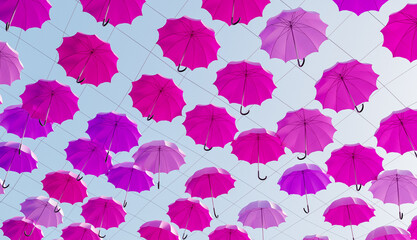 Fototapeta na wymiar many pink umbrellas hanging in the street