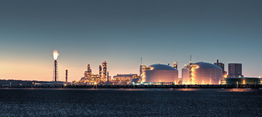 Fertilizer plant in an agricultural landscape at sunset. Railroad tanker cars stretched across the...