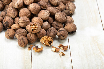walnuts spilled from the basket on the white wooden