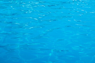 Perfect texture of clear blue water in the swimming pool, ocean or sea. Top view. copy space. shimmering water. Abstract background