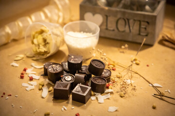 Handmade candies with fresh and dried fruits on light paper background in rustic style