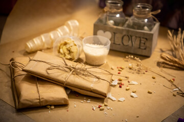 Handmade chocolate with fresh and dried fruits in wrapping on light paper background in rustic style