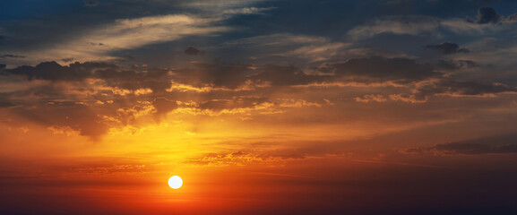 Sky at sunrise, dawn, clouds, sun and rays.