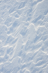 Fresh clean white snow background texture. Winter background with frozen snowflakes and snow mounds. Snow lumps. Seasonal landscape details. Cold weather.