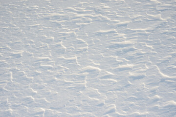 Fresh clean white snow background texture. Winter background with frozen snowflakes and snow mounds. Snow lumps. Seasonal landscape details. Cold weather.