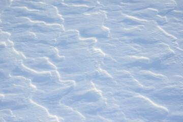 Fresh clean white snow background texture. Winter background with snowflakes and snow mounds. Snow lumps. Seasonal landscape details.