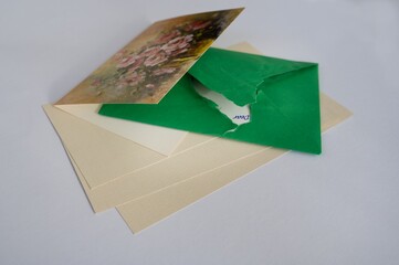 Still life with correspondence, torn green envelope impatiently open
and greeting card.