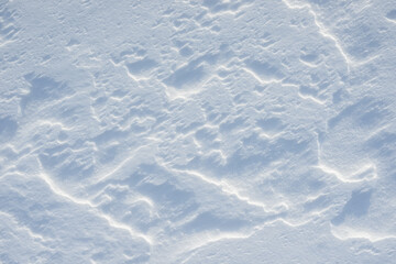 Fresh clean white snow background texture. Winter background with frozen snowflakes and snow mounds. Snow lumps. Seasonal landscape details. Cold weather.