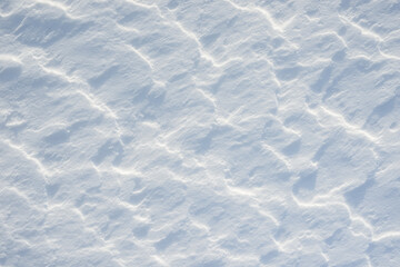 Fresh clean white snow background texture. Winter background with snowflakes and snow mounds. Snow lumps. Seasonal landscape details.