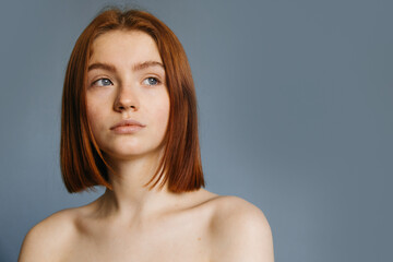 Woman without make up with short ginger hair