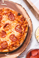 pepperoni pizza with mozzarella cheese and homemade dough on a marble background
