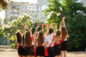 selective focus. a group of high school graduates happily throw up medical masks as a symbol of the end of quarantine.