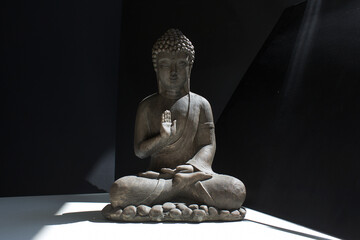buddha statue on black and white background   practicing meditation yoga mindfulness concept
