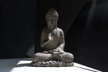 Zelfklevend Fotobehang buddha statue on black and white background   practicing meditation yoga mindfulness concept © АliVa