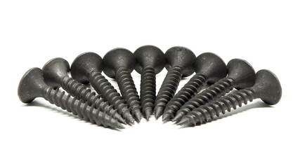 Heap of black steel screws arranged in a radial pattern. Sutio shot