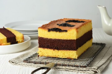 spiku lapis surabaya or three layers of sponge cake made from lots of egg yolks with strawberry jam...