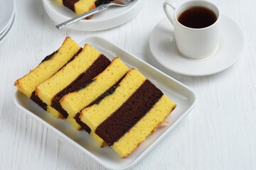 spiku lapis surabaya or three layers of sponge cake made from lots of egg yolks with strawberry jam between the layers, served for Christmas, Chinese New Year or Eid and Eid Al-Adha