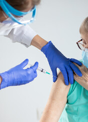 elderly woman getting coronavirus vaccine
