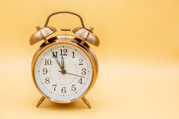 old clock symbolilizes time shortness for things like vaccination and dates ,bottleneck and hurry with yellow background