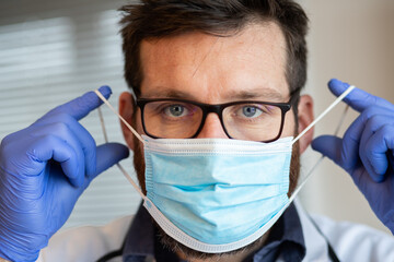 doctor putting on medical mask