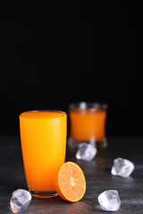 Fresh homemade orange juice in glass with ice on vintage wooden table. Freshness beverage fruit for healthy and diet with top copy space for your advertising content.
