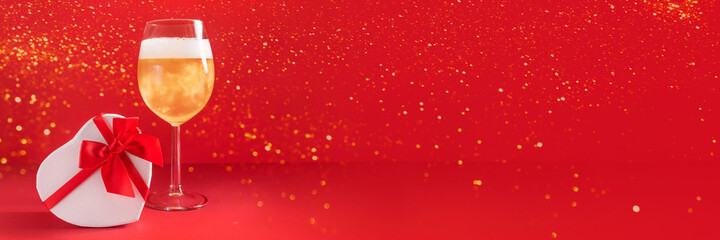 Banner with glass of champagne, heart shaped gift box and lights on red background. Romantic present for Valentine's Day, womens day, mothers day