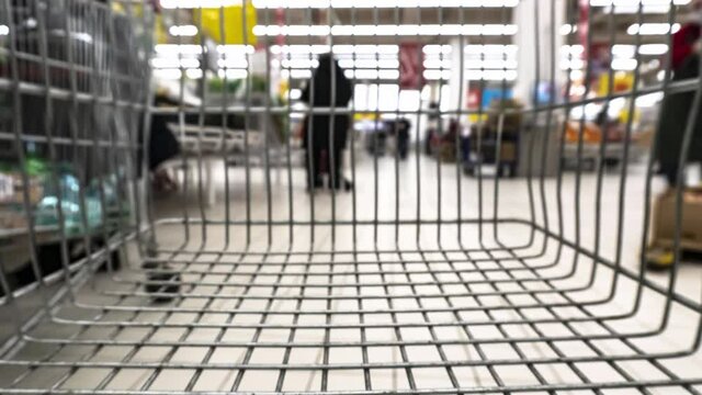 View of the supermarket shopping hall from the shopping cart, time lapse