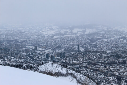 Beautiful view of Sarajevo in winter. Sarajevo under the snow. View of snowy Sarajevo from the mountain Trebevic.