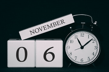 Obraz premium Important date and event on a black and white calendar. Cube date and month, day 6 November. Autumn season.
