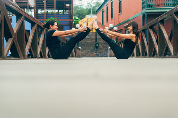 Latina women doing a yoga posture outdoors. Copy space