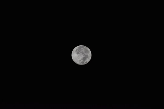 New moon in the middle of the black dark sky