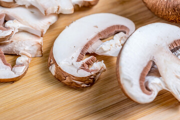 Royal champignons, chopped mushrooms on wooden board close-up