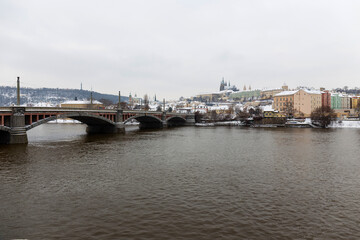 Snowy Prague Lesser Town with Prague Castle above River Vltava, Czech republic