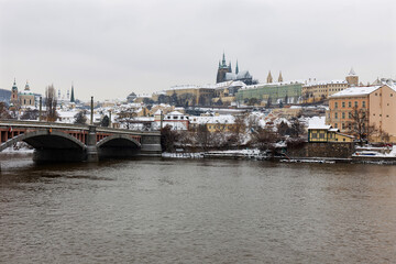 Snowy Prague Lesser Town with Prague Castle above River Vltava, Czech republic