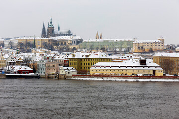 Naklejka premium Snowy Prague Lesser Town with Prague Castle above River Vltava, Czech republic