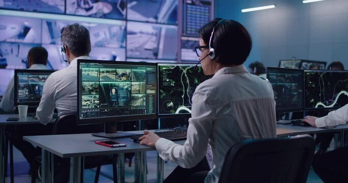 Woman speaking on headset while watching camera footage