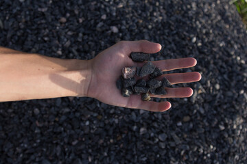 hands of the person with rocks