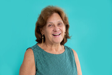 happy senior woman looking and smiling to the camera on colorful background