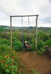 A woman and puppy are enjoying beautiful garden.