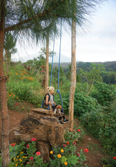 A woman and puppy are enjoying beautiful garden.